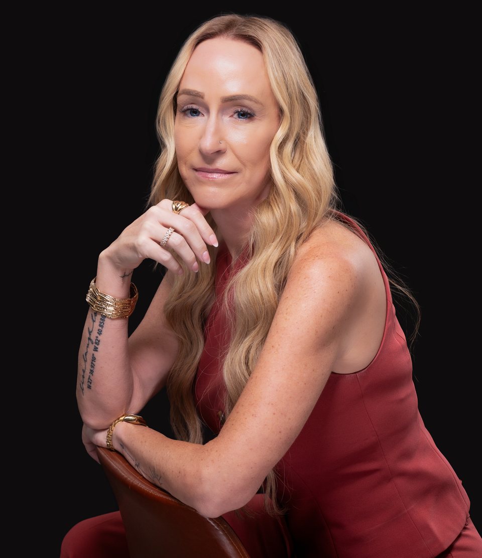 Stacey Melton, mortgage broker in Phoenix and Tampa Bay, in a red top, leaning on the back of a chair